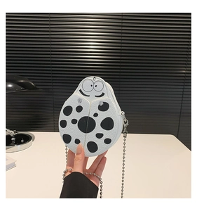 Detailed close-up of a cute ladybug-shaped PU leather crossbody bag with polka dots