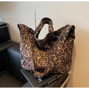 Detailed macro view of large capacity tote bag featuring leopard print and soft fabric