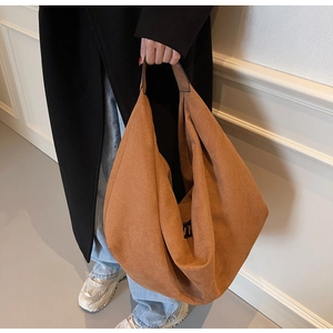Detail of the large caramel suede tote bag showing its soft texture and spacious capacity