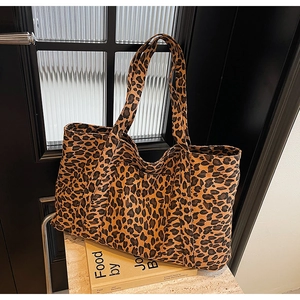 Close-up of leopard print tote bag on marble surface with detailed fabric texture