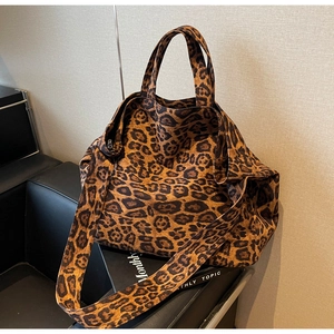 Macro shot of large leopard print canvas tote bag with thick texture and wide shoulder strap