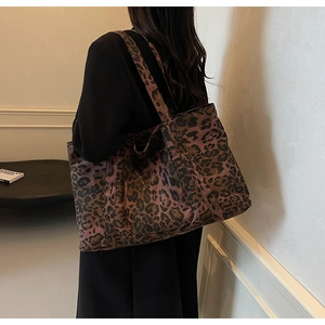 Close-up of a large leopard print tote bag with thick fabric strap for daily use