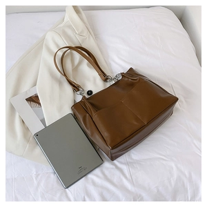 Top view of dark brown PU leather tote bag with silver chain details and front pockets