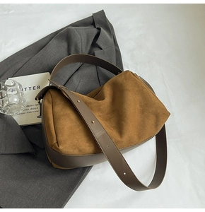 Detailed top view of retro brown suede shoulder bag with smooth leather strap details