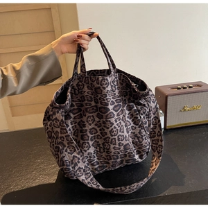 Detailed view of leopard print tote bag with soft fabric texture and sturdy shoulder strap