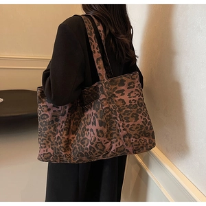 Close-up of leopard print canvas tote bag with wide shoulder straps in casual style
