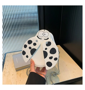 Close-up of a white ladybug-shaped mini bag with polka dots and silver bead chain
