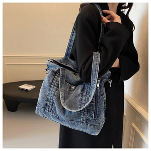 Detailed close-up of retro denim tote bag featuring side zipper pocket and washed texture