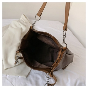 Macro view of brown PU leather tote bag interior with a functional zipper pocket