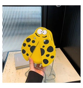 Detail of yellow ladybug mini bag in litchi pattern PU leather with a metal chain strap