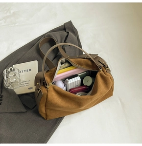 Spacious brown suede tote bag interior filled with laptop, wallet, and essentials