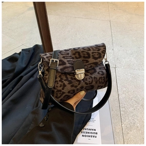 Detail of leopard print crossbody bag with silver buckle and dual shoulder straps