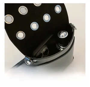 Detail view of the black leather crossbody bag interior showing phone and lipstick capacity