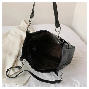 Top view of large black tote bag interior with zipper compartment and silver chain straps