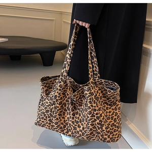 Detailed close-up of large leopard print tote bag in durable canvas with dual handles