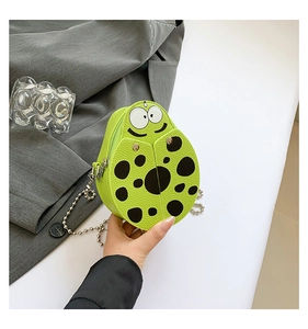 Detail of lime green ladybug mini bag with lychee texture and silver bead chain
