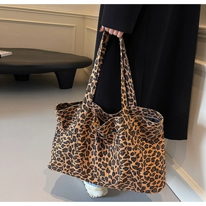 Detail of a large leopard print canvas tote bag showing its spacious design and wide straps