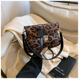 Close-up of leopard print crossbody bag featuring a silver metal lock and black leather strap