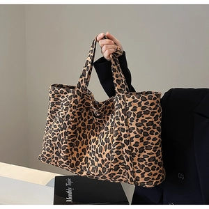 Close-up of leopard print tote bag with reinforced shoulder strap and front pocket