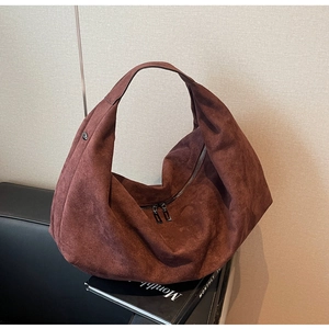 Detailed texture of chocolate brown faux suede hobo bag with dual gunmetal zippers