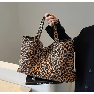 Fashionable leopard print tote bag styled with a professional black blazer outfit