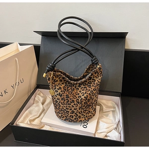 Leopard print tote bag with golden flower charm inside a premium black gift box packaging