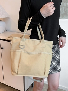 Minimalist beige canvas tote bag with multi-pockets and adjustable shoulder strap for daily use