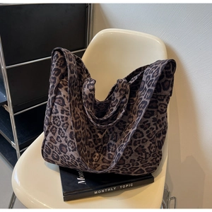 Close-up of leopard print tote bag on a white chair in a stylish lifestyle setting