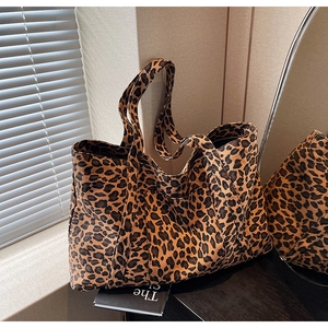 Detailed view of leopard print tote bag with thick canvas texture and sturdy handles