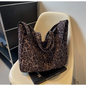 Detailed close-up of large capacity leopard print tote bag with thick canvas fabric texture