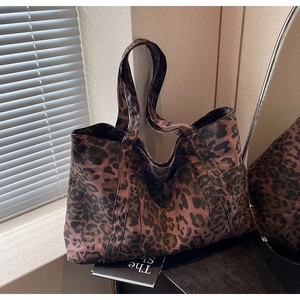 Detailed view of the leopard print canvas tote bag featuring premium fabric textures