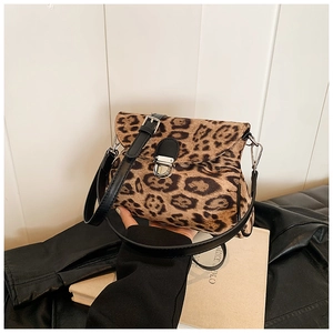 Detail of leopard print crossbody bag with silver metal lock and faux fur texture