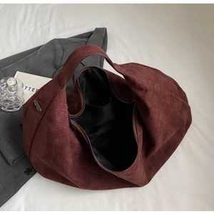 Top view of spacious burgundy suede tote bag interior with zipper and accessory pocket
