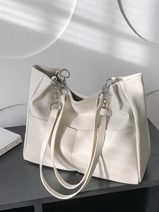 Off-white oversized leather tote bag with silver chain straps and double front pockets