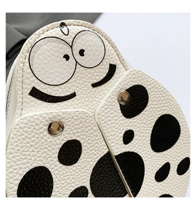 Close-up of kids ladybug crossbody bag showing white lychee texture and black polka dots