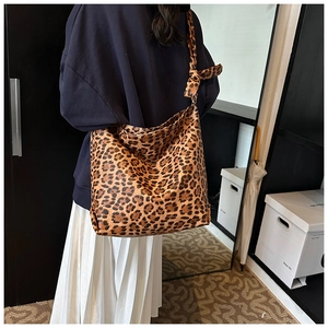 Detail view of large leopard print canvas tote bag with adjustable knotted shoulder strap