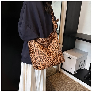 Detailed side view of leopard print hobo bag showing large capacity on shoulder