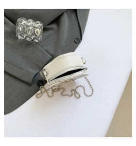 Top view of white pebble-grain leather crossbody bag with silver beaded chain strap