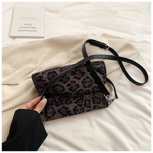 Close-up of leopard print plush shoulder bag with fine black strap and silver hardware