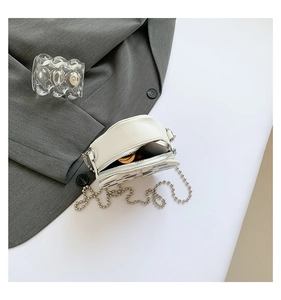 Detail view of mini round cow print crossbody bag showing inner space for small items