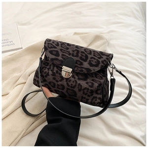 Detail of grey leopard print crossbody bag with metallic twist lock and velvet texture