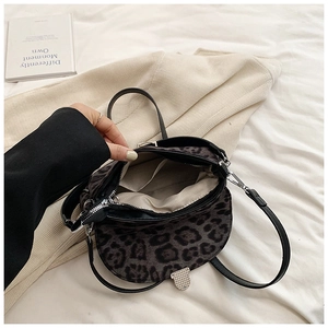 Top view of leopard print crossbody bag showing inner compartment and silver clasp
