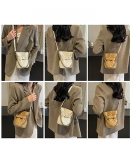 Quilted diamond pattern bucket bag with gold chain strap in white and khaki colors