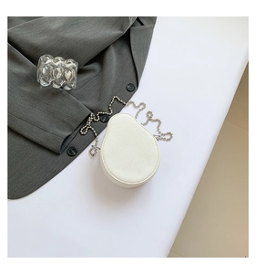 Detail of white avocado-shaped mini bag with lychee grain PU leather and silver bead chain
