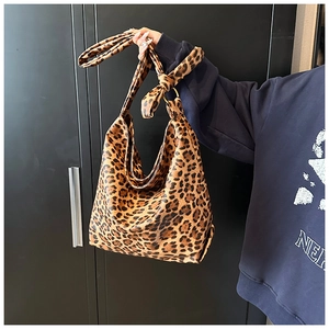 Detail of leopard print hobo bag showing the textured faux leather and metal ring buckle