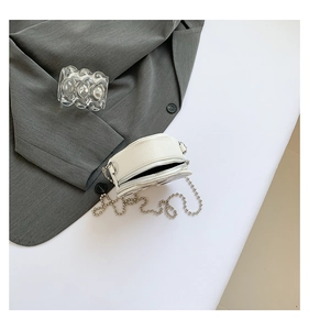 Top view of a white PU leather mini round crossbody bag with a silver bead chain strap