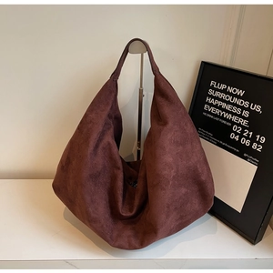Detail of burgundy faux suede hobo bag showing soft matte texture and large capacity