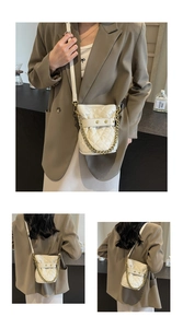 Detail of white quilted bucket bag featuring a classic rhombus pattern and gold chain strap