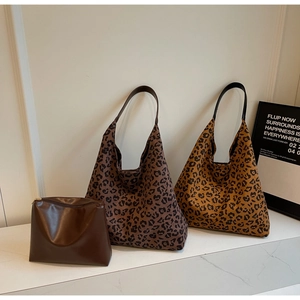 Ensemble de trois sacs à imprimé léopard et pochette marron sur une table en marbre