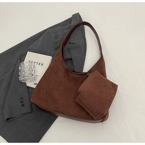 Vue détaillée du sac hobo en daim marron avec pochette zippée et accessoires de mode